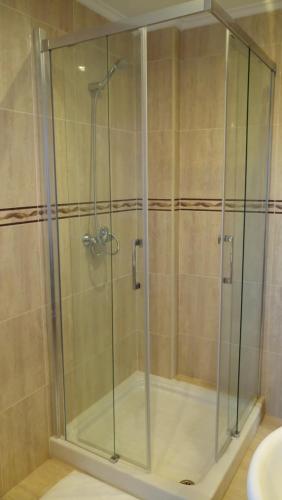 a shower with a glass door in a bathroom at CHALET CERCA DE NOJA CON ACCESO A SPA in Beranga