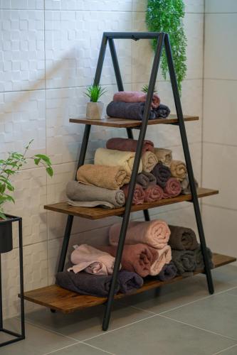a towel rack with a bunch of towels on it at GRANDMA´S HOUSE in Stankovci