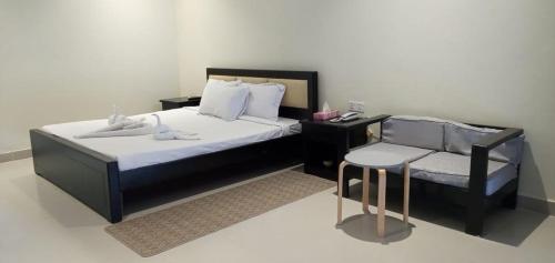 a hotel room with a bed and a chair at Marina Beach Villas Resort in Cox's Bazar