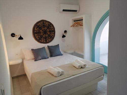 a bedroom with a bed with towels on it at Plaka's house seaside view in Plaka