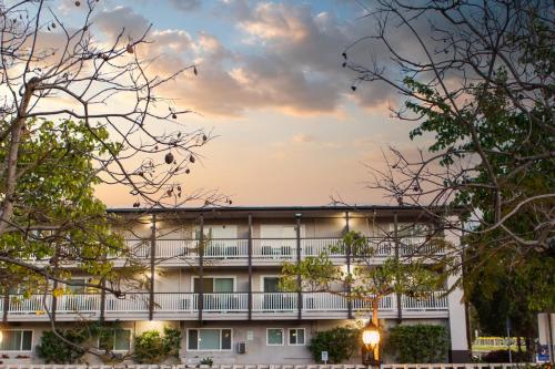 an exterior view of a building with trees at Avania Inn of Santa Barbara in Santa Barbara