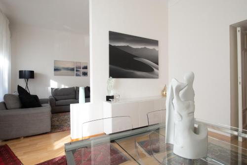 a living room with a white couch and a glass table at Civico11 in Ancona