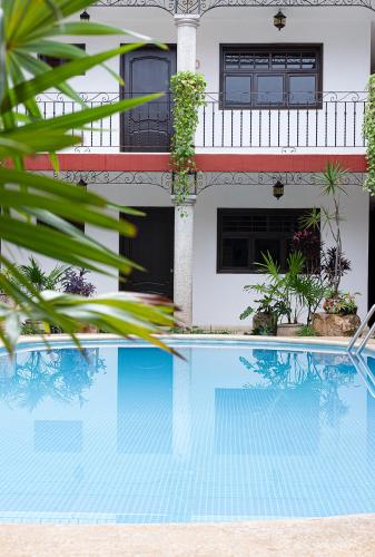 a house with a swimming pool in front of a house at La Aurora Hotel Colonial in Valladolid