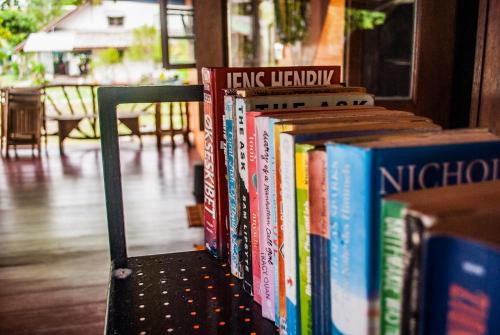 a row of books sitting on a shelf at BB Dorm Koh Kood in Ko Kood