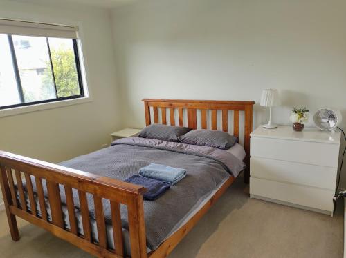 a bedroom with a bed with two pillows and a window at Not entire house!! Cozy two bedrooms with private bathroom and parking in Point Cook