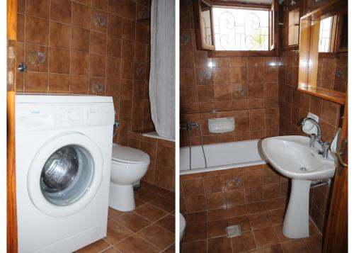 a bathroom with a washing machine and a sink at Ekavi Apartments in Sitia