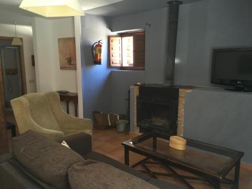 a living room with a couch and a fireplace at Casa Clemente I in La Hiruela