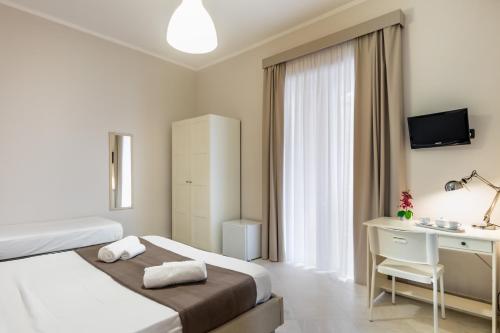 a hotel room with a bed and a desk at Nonna Nina in Avola