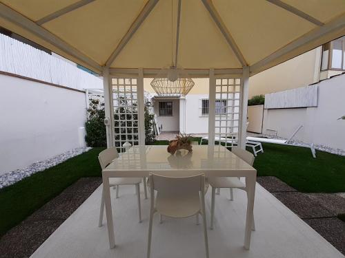 a white table and chairs under a tent at MINZONI94 - TwoBedroom+Garden in Lido di Camaiore