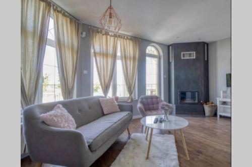a living room with a couch and a table at Villa Smestaj Dunav in Novi Banovci