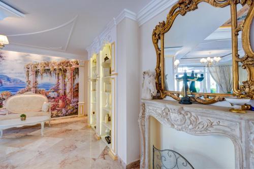 a living room with a mirror and a fireplace at Izida Palace Apartments in Sunny Beach