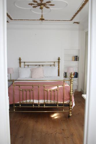 a bedroom with a large bed with a pink blanket at The Little Olive Quinta in Alvaiázere