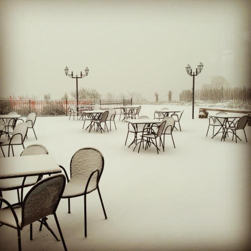 a group of tables and chairs covered in snow at Enolocanda Del Tufo in Dogliani