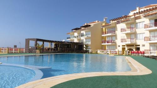a large swimming pool in front of a building at Boa Vista Holiday Apartment in Sal Rei