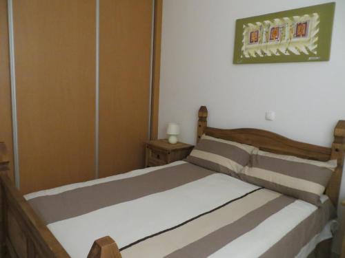 a bedroom with a bed and a picture on the wall at Boa Vista Holiday Apartment in Sal Rei