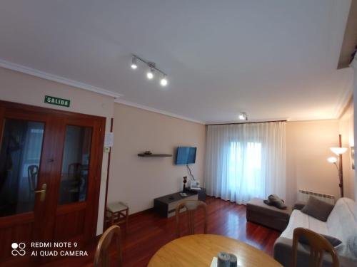a living room with a couch and a table at Pedroenea Apartamento Elizondo in Elizondo
