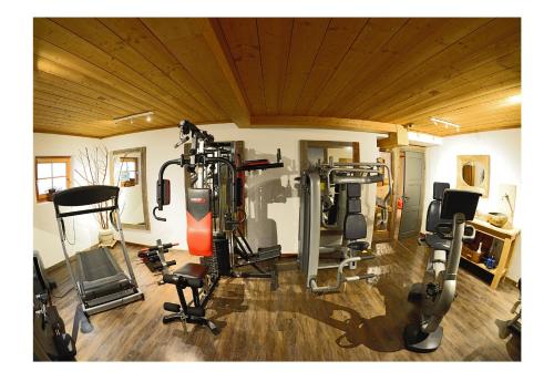 a room with a gym with several tread machines at Das Landhaus in Pfronten