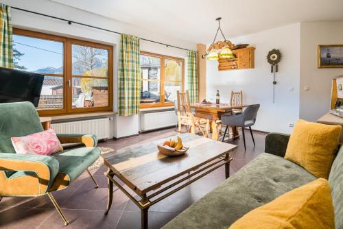 a living room with a couch and a table at Zur Schönen Aussicht Hotel garni in Garmisch-Partenkirchen