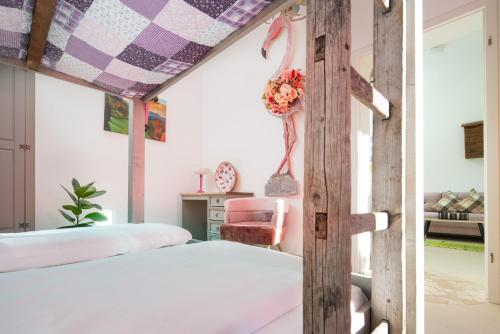 a bedroom with a large bed and a chair at Zur Schönen Aussicht Hotel garni in Garmisch-Partenkirchen