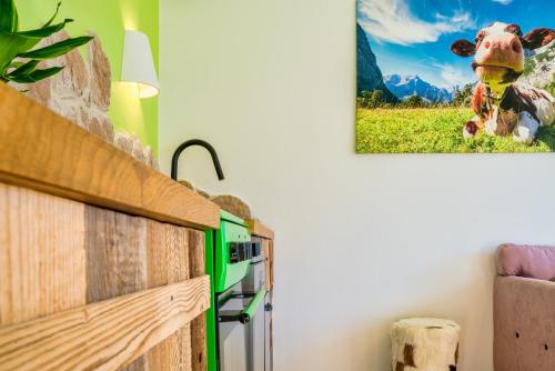 a picture of a cow on the wall in a room at Zur Schönen Aussicht Hotel garni in Garmisch-Partenkirchen