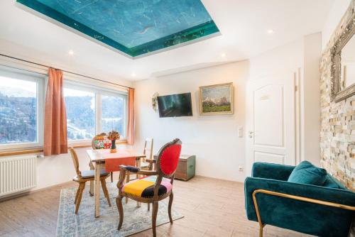 a living room with a table and chairs at Zur Schönen Aussicht Hotel garni in Garmisch-Partenkirchen