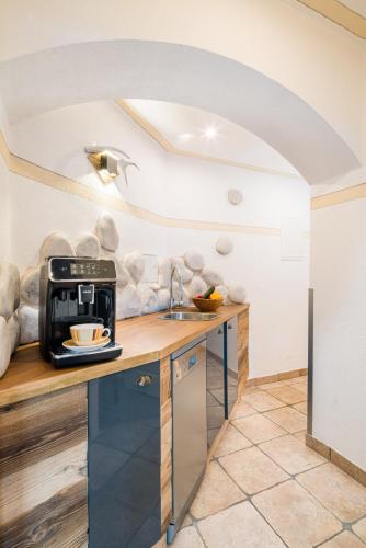 a kitchen with a coffee maker on a counter at Zur Schönen Aussicht Hotel garni in Garmisch-Partenkirchen