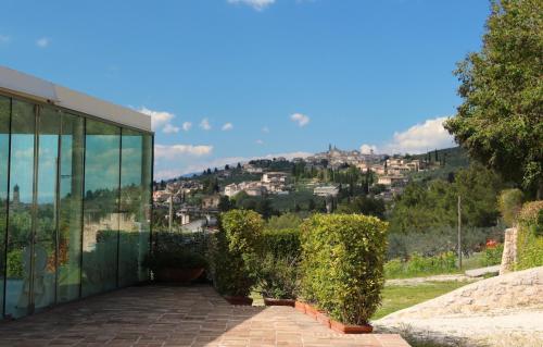a glass building with a view of a city at Corte Fratini Appartamenti in Trevi
