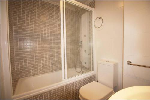 a white bathroom with a toilet and a shower at La Manga Beach Club LMHA 03 in Murcia