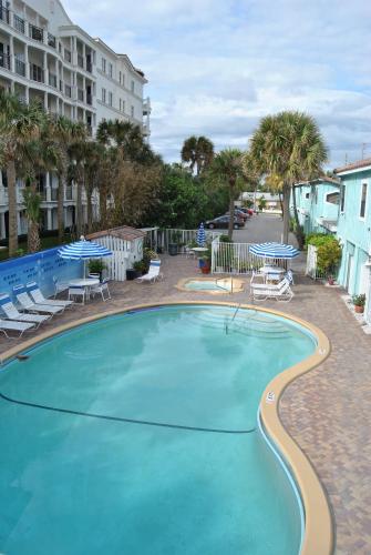 una gran piscina con sillas y mesas en Sand Dune Shores, en Palm Beach Shores