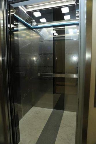 a glass door of a elevator in a building at City Central Apartment in Yerevan