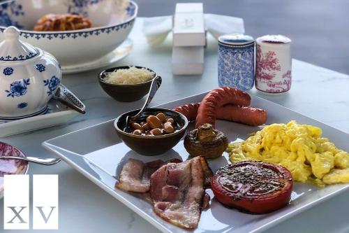 a plate of breakfast food on a table at City Central Apartment in Yerevan