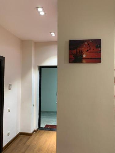 a room with a painting on the wall and a door to the ocean at City Central Apartment in Yerevan