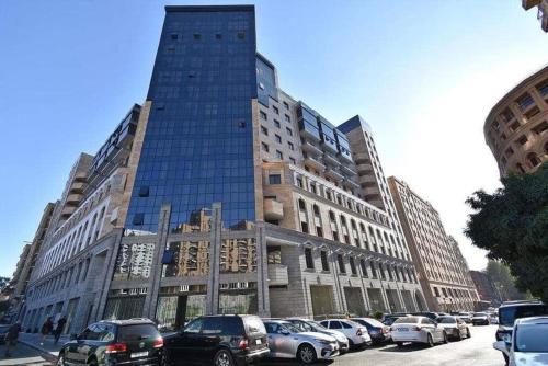 a large building with cars parked in front of it at City Central Apartment in Yerevan