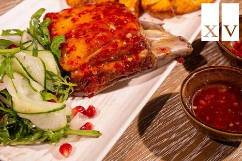 a plate of food on a table with a salad at City Central Apartment in Yerevan
