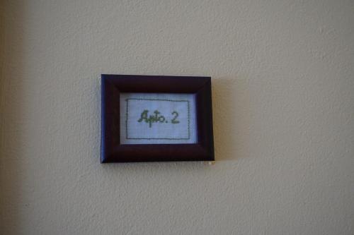 a picture on a wall with a frame on it at Apartahotel Montecaoru in Arenas de Cabrales