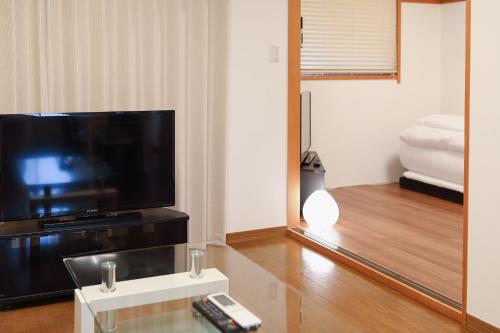 a living room with a large flat screen tv at Mon Petit Chat in Kanazawa