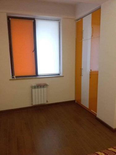 an empty room with a large window on the wall at City Central Apartment in Yerevan