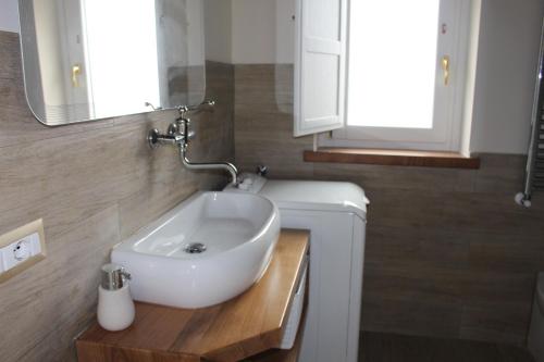 a bathroom with a white sink and a mirror at Dimora Igea b&b in Montano Antilia