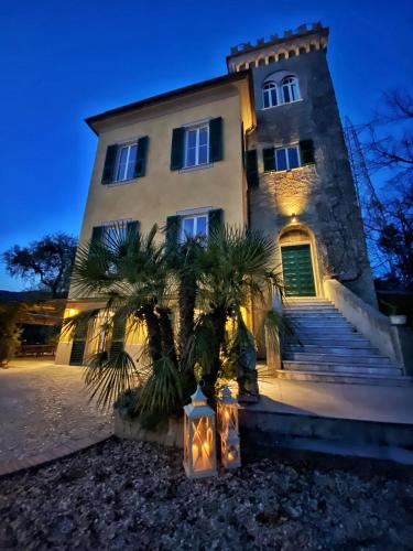 a building with a tree in front of it at Torre Scribanti in Sestri Levante