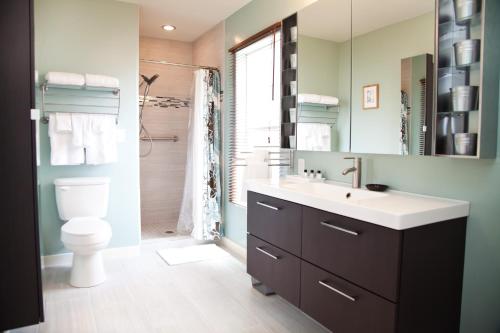 a bathroom with a sink and a toilet and a shower at The Flagstone Boutique Inn & Suites in Kanab