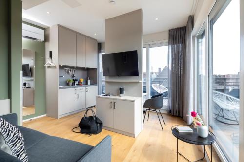 a living room with a couch and a table at zeitwohnhaus SUITE-HOTEL & SERVICED APARTMENTS in Erlangen