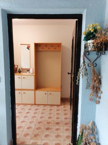 a doorway into a room with a dresser and a mirror at Bela golobica Bogojina in Bogojina
