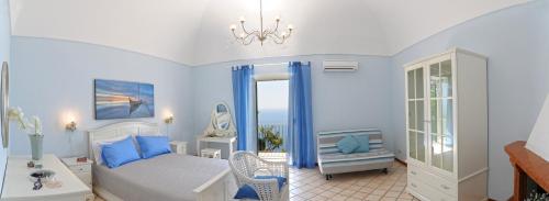 a bedroom with blue walls and a bed and a window at Palazzo Rocco all 3 villas - Weddings in Praiano