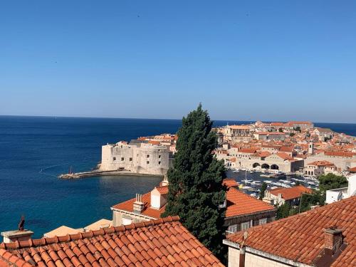 a view of a town with red roofs and the ocean at Villa Leoni in Dubrovnik