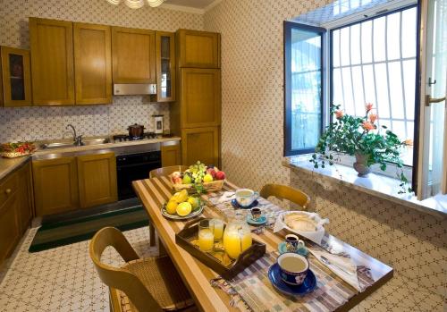 a kitchen with a wooden table with fruit on it at DON VALERIO SORRENTO in Sorrento