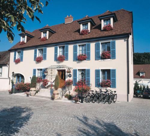 a white building with bikes parked in front of it at Hotel Pinocchio in Gy