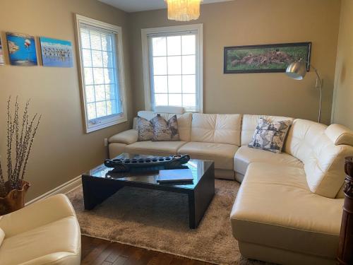 a living room with a couch and a coffee table at Explorer House Bed & Breakfast in Niagara on the Lake