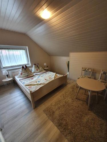 a bedroom with a bed and a table in a room at Apartman Ilike in Balatonfüred