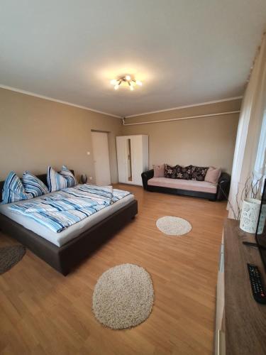 a large room with a bed and a couch at Ilike Home in Balatonfüred