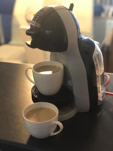 a coffee maker is making a cup of coffee at The Little Boat House in Talsarnau